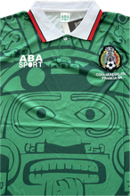 Load image into Gallery viewer, Green sports jersey with ABA Sport branding and a face design on a white background