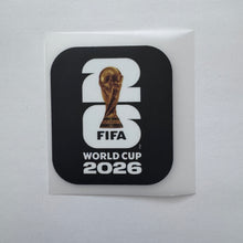 Load image into Gallery viewer, A square sticker featuring the FIFA World Cup 2026 logo, with a black rounded square design over a white backing sheet. The design includes a large stylized '26' with the gold FIFA World Cup trophy inside the '2', the word 'FIFA', and 'WORLD CUP 2026' in white text.