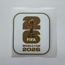 Load image into Gallery viewer, A square white sticker featuring the official FIFA World Cup 2026 logo in brown and gold, displayed on a light gray background.