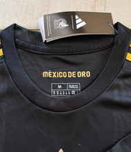 Load image into Gallery viewer, "Mexico de Oro Jersey Close-Up Detail - 2025 Adidas Black & Gold Special Edition with Official Mexican Crest, Premium Fabric Construction, and Gold Accent Features" Neck Tag
