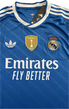 Load image into Gallery viewer, Real Madrid 2025-26 Adidas Originals Jersey with Intercontinental & 15 front view, including Adidas logo, Real Madrid logo and Patch