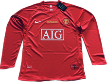 Load image into Gallery viewer, Manchester United Ronaldo UCL Final Jersey Side Detail View - Authentic Nike Long Sleeve Soccer Jersey Showing Official UEFA Champions League Patches, AIG Sponsor Logo, and Premium Fabric Construction