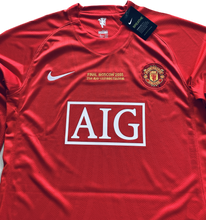 Load image into Gallery viewer,  Manchester United UCL Final 2007/2008 Jersey Sleeve and Shoulder Detail - Nike Long Sleeve Soccer Jersey with Official Champions League Patches, Premium Red Fabric, and Authentic Ronaldo Era Design Elements