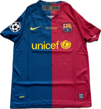 Load image into Gallery viewer, A men's FC Barcelona soccer jersey from the 2009 Champions League final, with a split blue and red design, featuring the unicef logo and other sponsor markings.
