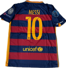 Load image into Gallery viewer, Back view of a striped sports jersey with 'MESSI 10' and 'unicef' printed on the lower part, predominantly blue with red stripes, indicating it was worn in a Champions League game.