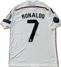 Load image into Gallery viewer, The image shows a white Adidas soccer jersey with the name 'RONALDO' and the number '7' on the back, along with the patch for the 2014 2015 Real Madrid team and the UEFA Champions League patch.