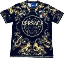 Load image into Gallery viewer, A black and gold soccer jersey with Versace branding and Medusa head design.