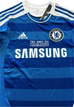 Load image into Gallery viewer, Close-up detail of Chelsea jersey showing Adidas logo, Champions League patch, and premium fabric quality