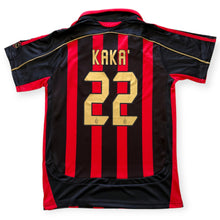 Load image into Gallery viewer, AC Milan home jersey back view featuring red and black vertical stripes with gold lettering reading 'KAKA' and number '22' on a white background.