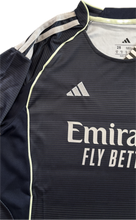 Load image into Gallery viewer, Real Madrid 2025-26 Youth Away Kit (Jersey + Shorts) - Adidas Champions League close-up of the Adidas logo, embroidered and partial emirates jersey logo