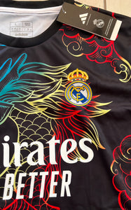 Adidas sports jersey with colorful dragon design and Real Madrid logo
