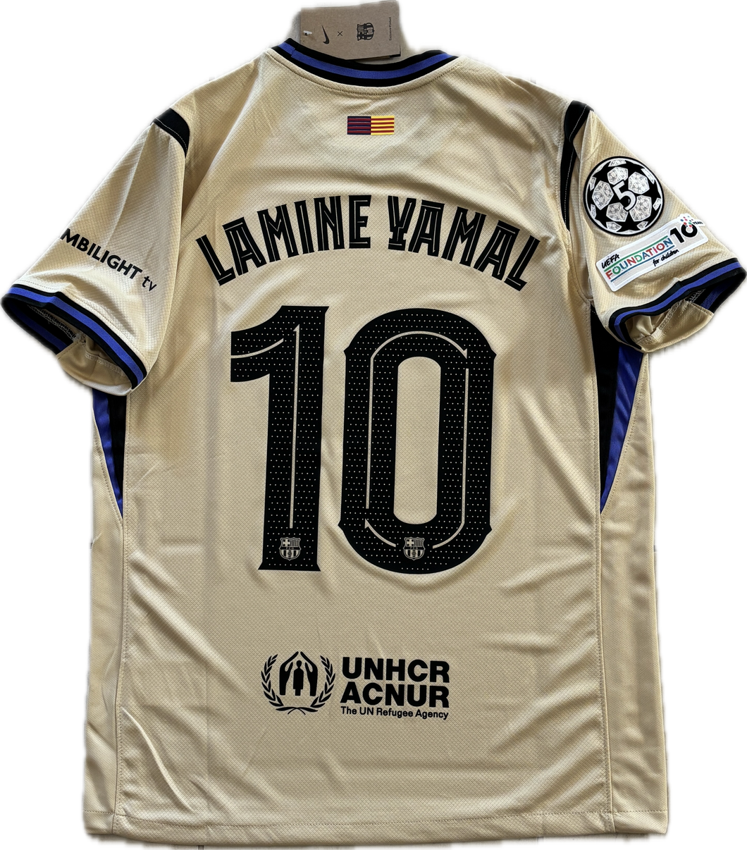 Beige sports jersey with 'Lamine Yamal 10' printed on it, featuring UNHCR ACNUR logo. Back View Nike Barcelona