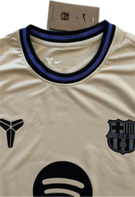 Load image into Gallery viewer, &quot;Nike FC Barcelona x Kobe Mamba Lamine Yamal #10 Jersey Product Shot - Special Edition Beige Champions League Kit with Official Crest, Player Font, and Tribute Colorway&quot;

