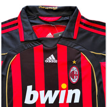 Load image into Gallery viewer, AC Milan home soccer jersey by Adidas, featuring red and black vertical stripes with gold trim, the Adidas logo, AC Milan crest, and bwin sponsor logo.

